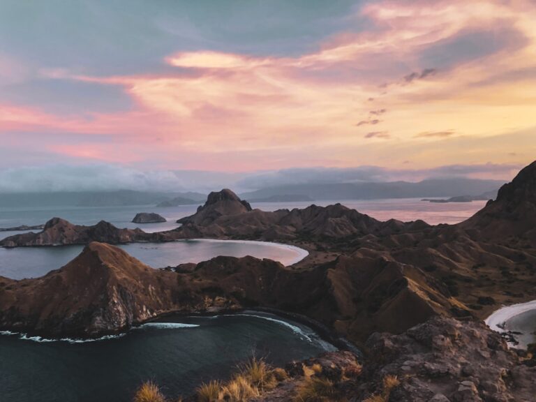 Padar Island panorama at sunrise showing three bays and rugged ridgeline, Komodo National Park, Indonesia
