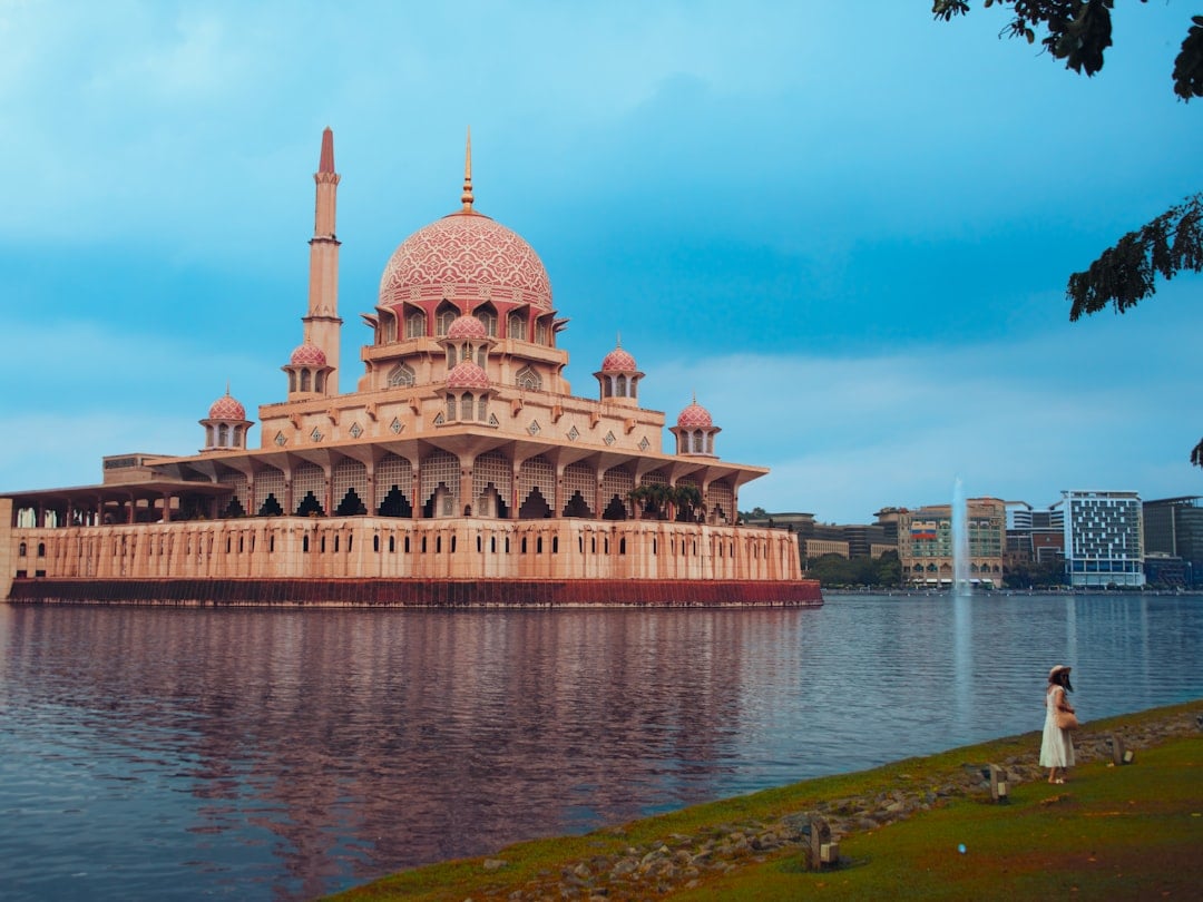 Putra Mosque with its rose-pink dome reflected in Putrajaya Lake, Malaysia
