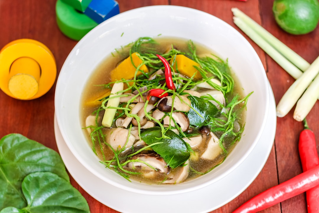 A bowl of Khmer food, a herbal broth with fresh vegetables, lemongrass and chilli, typical of Cambodian cuisine