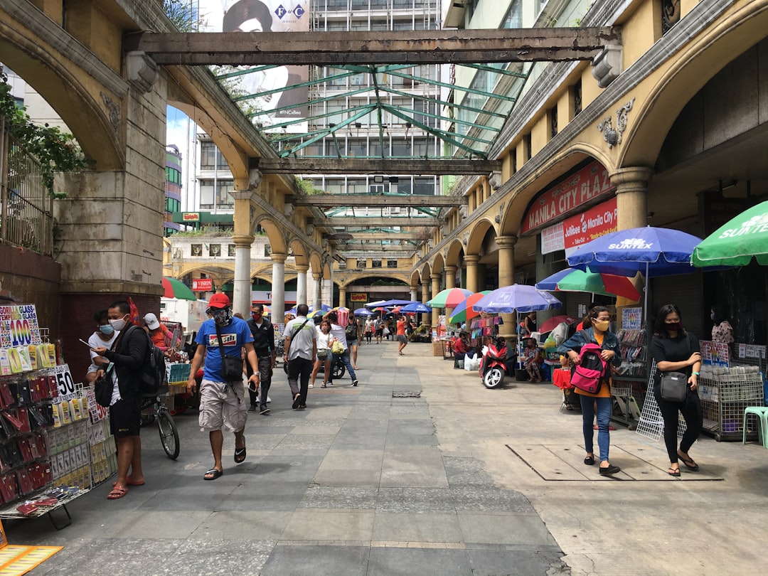 Busy covered market street in Quiapo Manila Philippines with vendors and shoppers