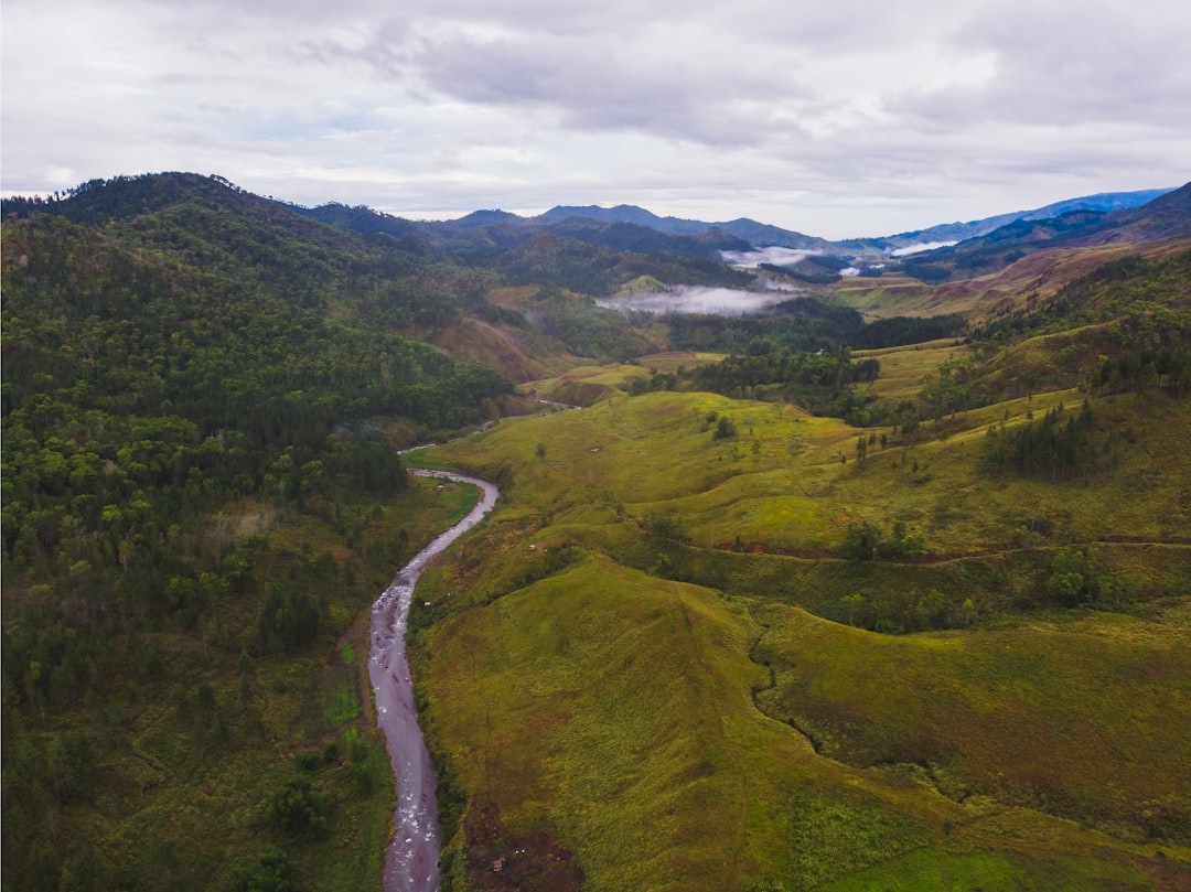 Aerial view of a winding mountain road through lush green Philippine highlands, typical of Cordillera routes to Sagada and Banaue