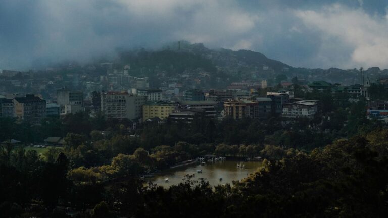 Baguio City Philippines aerial view showing the mountain city nestled in misty hills with Burnham Park lake visible