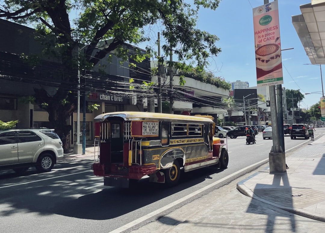 Colourful jeepney local bus driving along a Manila street Philippines