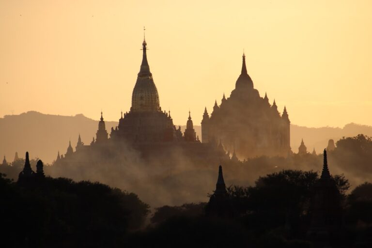 Ancient Bagan temples silhouetted against a golden hazy sunrise sky, Myanmar